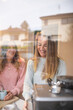 © Austockphoto - Looking through kitchen window at same sex couple making coffee