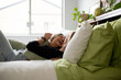 © Austockphoto - Female same sex couple  affectionately lying together on the bed, hugging and laughing together