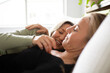 © Austockphoto - Female same sex couple  affectionately lying together on the bed