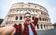 © Davide Angelini - Happy tourist visiting Colosseum in Rome, Italy - Young man taking selfie in front of famous Italian landmark - Travel and holidays concept