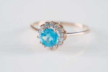 Wall Mural - beautiful ring with blue topaz and many white diamonds on white background