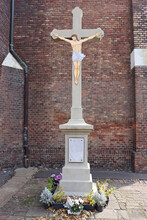 Jesus Christ Figure On The Cross In Front Of The Brick Wall Of The Church