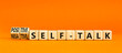 © Dzmitry - Positive or negative self-talk symbol. Concept words Positive self-talk and Negative self-talk on cubes. Beautiful orange background. Psychological positive or negative self-talk concept. Copy space.