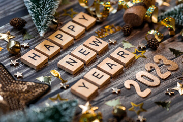 Canvas Print - Banner. The symbol of the number 2023 with golden balls, stars, sequins and a Christmas tree on a wooden background. The concept of celebrating a Happy New Year 2023 and Christmas.