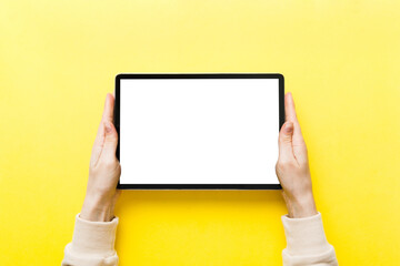 female teen hands using tablet pc with white screen, Mockup image of woman hand holding white tablet pc with blank white screen at home