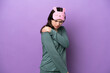 © luismolinero - Young Russian woman in pajamas isolated on purple background suffering from pain in shoulder for having made an effort