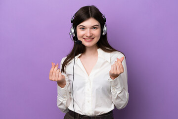 Wall Mural - Telemarketer Russian woman working with a headset isolated on purple background making money gesture