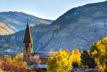 Aspen, Colorado Ski Resort Town With Chapel Church Bell Tower Building In Autumn Fall And Early Winter With Snow In Mountain Valley