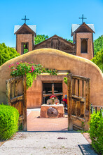 Famous Historic El Santuario De Chimayo Sanctuary Church In United States With Entrance Gate By Flowers In Summer