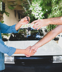 used car trade. Used car takes delivery. The man who bought the car reaches out for the car key.