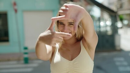 Sticker - Young blonde woman smiling confident doing photo gesture with hands at street