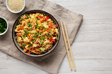 Homemade Cauliflower Fried Rice with Chives and Sesame Seeds in a Bowl, top view. Flat lay, overhead, from above. Copy space.