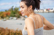 © Mat Hayward - Pretty Asian woman from behind. She is wearing a gray tank top and has a muscular back.