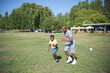 © KAMPUS - Portrait of happy African American dad and his son playing. Handsome man and little boy having active rest and running on green filed in summer. Leisure, sport activity and healthy lifestyle concept