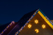 © Iurii Gagarin - The roof of a house decorated with garlands. Night background with selective focus and copy space for text