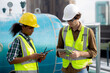 © NT_studio - Young woman and man engineer examining pipeline and looking digital tablet in the factory, mechanic or technician inspector plumber valve and talking together, industrial and maintenance concept.