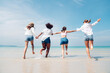 © kelvn - Happy friends at beach party runs together on the beach having fun in a sunny day, Beach summer holiday sea people concept