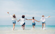 © kelvn - Happy friends at beach party runs together on the beach having fun in a sunny day, Beach summer holiday sea people concept