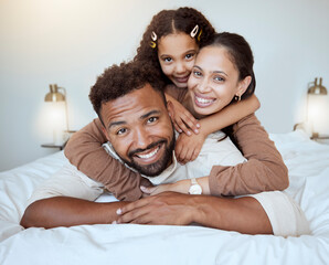 Wall Mural - Bed, happy family and girl in bedroom, happy and smile while bond, hug and having fun together. Love, portrait and black family of mother, dad and daughter rest, play and enjoy quality time in home