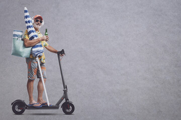 Wall Mural - Happy senior tourist going to the beach on a scooter