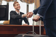 © Friends Stock - Close up photo of receptionist and client in expensive hotel shaking hands