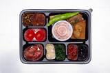 Fototapeta Storczyk - A delicious-looking lunch box with a variety of side dishes, fruits and tempura