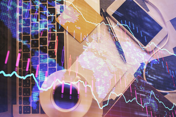 Wall Mural - Double exposure of financial chart drawing over table background with computer. Concept of research and analysis. Top view.