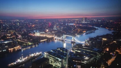 Wall Mural - time lapse London skyline with illuminated Tower bridge and Canary Wharf in sunrise time, UK