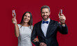 glad elegant couple cheering with champagne. occasion cheers. formal tuxedo couple cheering