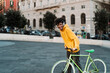 © Alessandro Biascioli - Happy young African man having fun with bike in the city while listening music with headphones - Youth millennial generation lifestyle and technology concept