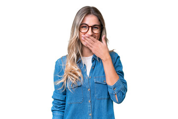 Wall Mural - Young Uruguayan woman over isolated background happy and smiling covering mouth with hand