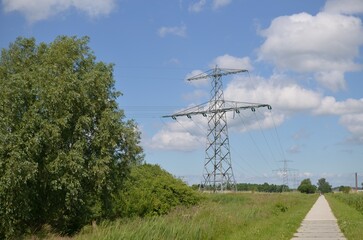 Wall Mural - Modern high voltage towers in field on sunny day