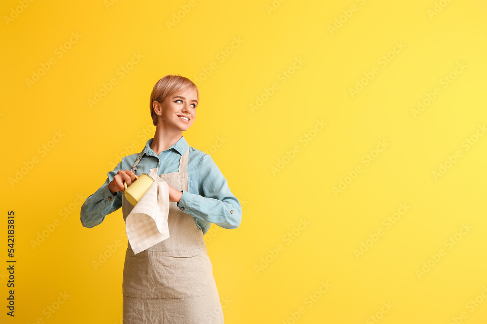 Female barista with cup and napkin on yellow background