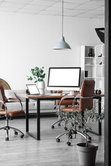 Interior of modern studio with photographer's workplace and professional equipment