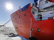 © Darr.di - Close up Red Nuclear-powered icebreaker cruise on sea ice with sun ray and bright blue sky, Arctic landscape, snow blizzard, Polar Sea, seaport