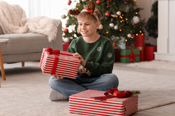 Sticker - Happy little children in reindeer horns with Christmas present at home