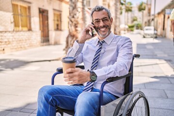 Sticker - Middle age hispanic man sitting on wheelchair talking on the smartphone at street