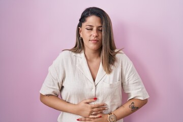 Canvas Print - Blonde woman standing over pink background with hand on stomach because indigestion, painful illness feeling unwell. ache concept.