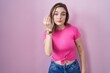 © Krakenimages.com - Blonde caucasian woman standing over pink background doing italian gesture with hand and fingers confident expression