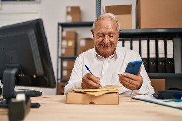 Poster - Senior man ecommerce business worker writing on package using smartphone at office