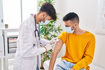 Canvas Print - Two man doctor and patient vaccinating at clinic