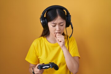 Sticker - Chinese young woman playing video game holding controller feeling unwell and coughing as symptom for cold or bronchitis. health care concept.