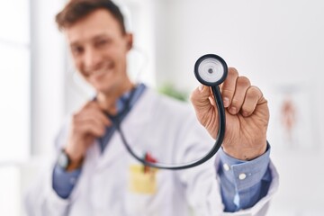 Canvas Print - Young man doctor smiling confident holding stethoscope at clinic