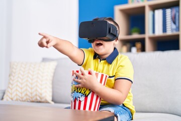 Sticker - Adorable hispanic boy watching 3d movie sititng on sofa at home