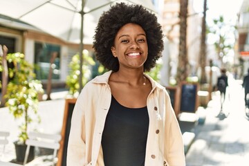 Sticker - Young african american girl smiling happy standing at the city.