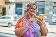 © Krakenimages.com - Young woman smiling confident listening to music at street