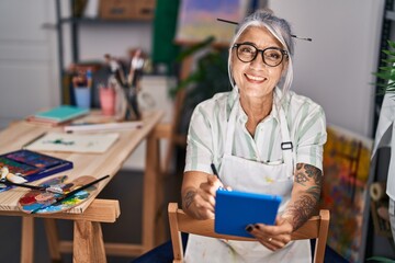 Poster - Middle age grey-haired woman artist smiling confident using touchpad at art studio