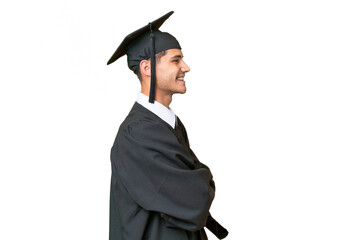 Young university graduate caucasian man over isolated background in lateral position