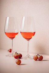 Wall Mural - Two glasses of rose wine and red grapes.