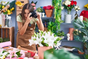 Young beautiful hispanic woman florist make photo to bouquet of flowes gift at flower shop